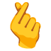 Hand mit gekreuztem Zeigefinger und Daumen